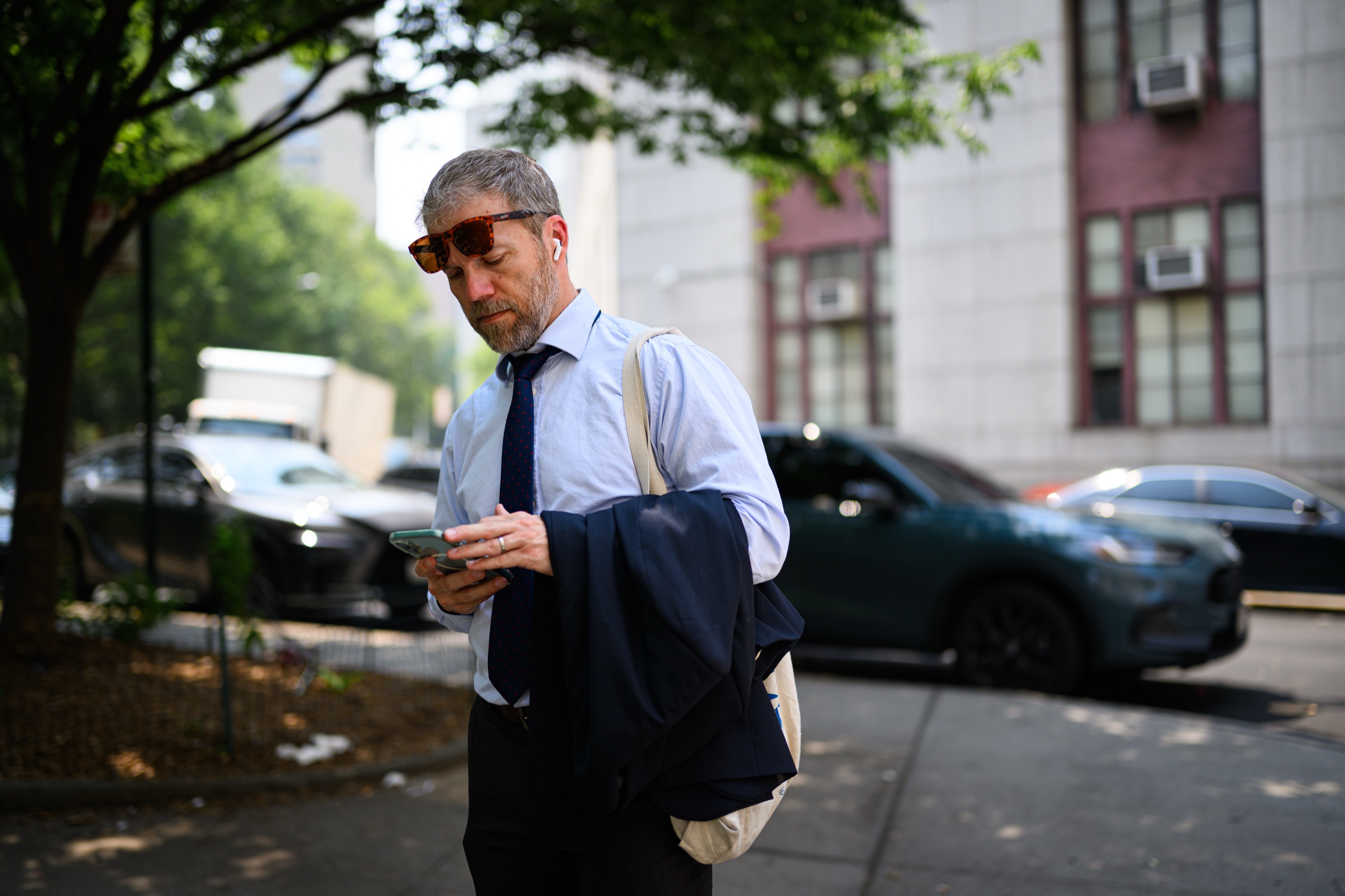 A lawyer checking his phone near the Manhattan courthouses
