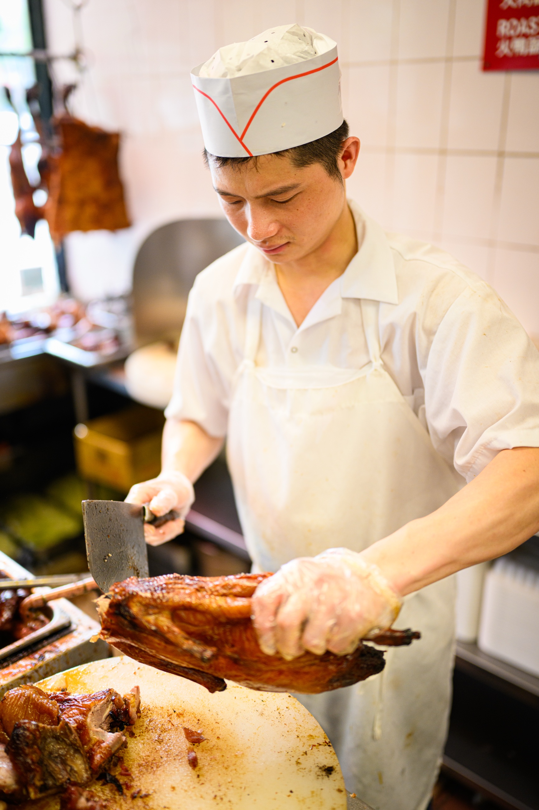 A chef chopping roast duck inside Wah Fung No. 1 Fast Food