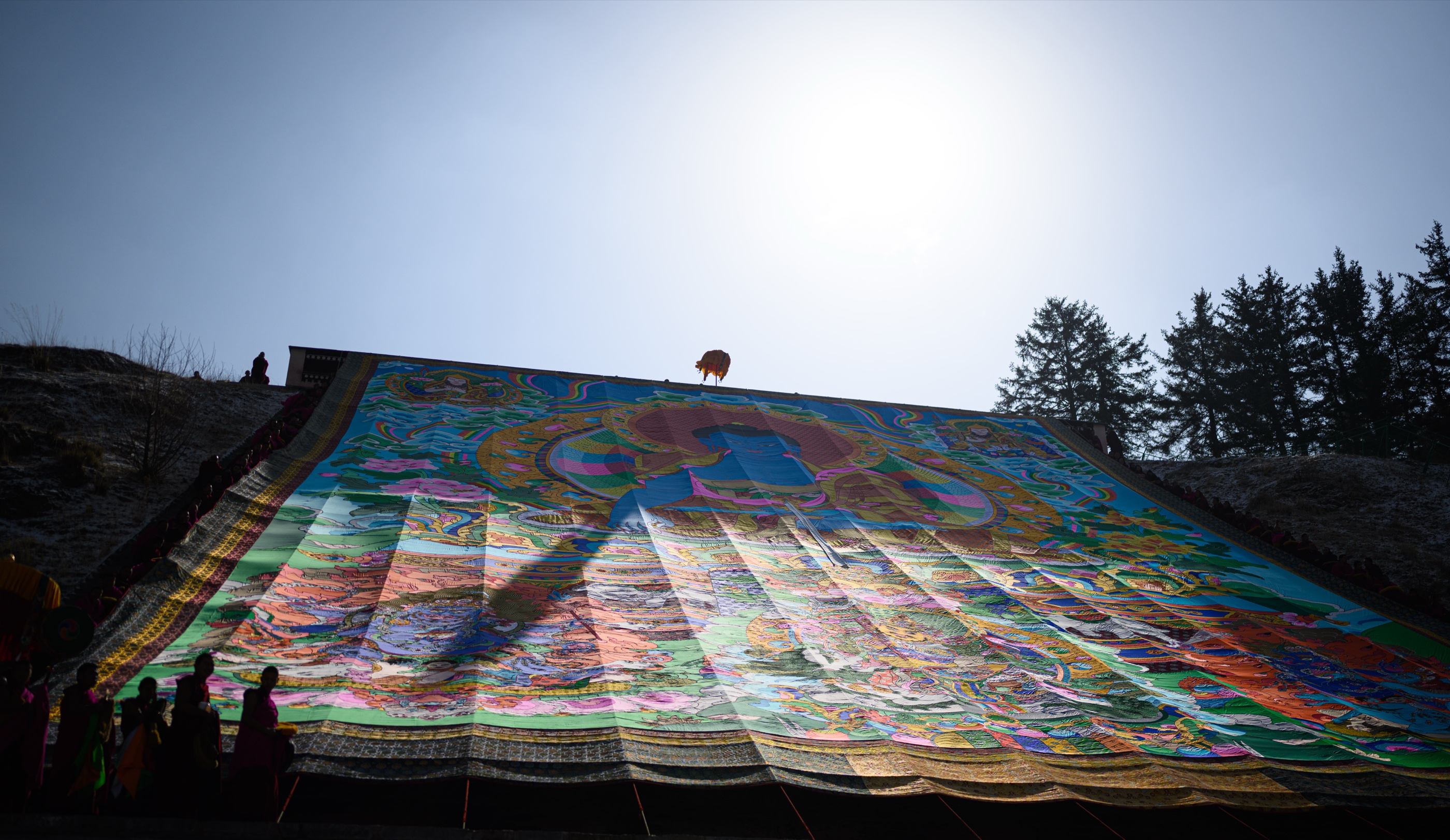 A monumental thangka unfurled beneath the winter sun